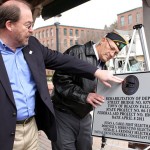 Selectman Michael Krenesky, left, admires a plaque commemorating the dedication of the Depot Street Bridge, along with Paul Block.