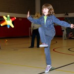 Lindsey Schulte, 8, plays “Catch a Run.” Each point of the star-shaped ball has a number that students had to add up.