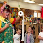 From left, Anthony Queiros, Layla Nemeth, and Aviana Ramos are delighted by Sparkles the Clown and her magic toilet paper during a performance at Tender Years Preschool May 13. Gigi Ramos, Aviana’s grandmother, hired Sparkles to entertain the kids.