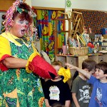 John DeBisschop holds up a missing scarf to Sparkles the Clown during a performance at Tender Years Preschool May 13. Gigi Ramos, grandmother of one of the other students in the class, hired Sparkles to entertain the kids.