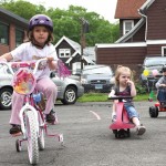 From left Hannah DeCampos, Alivia Stewart, and Matthew DosSantos trike around the parking lot of Tender Years Preschool in Naugatuck during the annual Trike-a-Thon May 20.