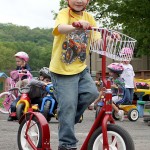 Joey Spina scoots around the parking lot of Tender Years Preschool in Naugatuck during the annual Trike-a-Thon May 20.