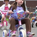 Maya Dias peddles around the parking lot of Tender Years Preschool in Naugatuck during the annual Trike-a-Thon May 20.
