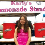 Karly Laliberte poses in front of her lemonade stand May 21.