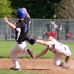 Naugatuck's Brian Pihonak tags his Crosby opponent out during the Hound's game May 9. - PHOTO BY LARAINE WESCHLER