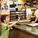 Western Elementary School teacher Michelle Baker, right, takes an order from Johnny Cordeiro, 7, and his mother, Danielle Cordeiro during Teacher's Night at McDonalds on Rubber Avenue in Naugatuck. Ten teachers worked at McDonald's from 5-8 p.m. June 2 to raise money for the school. Ten percent of sales will be donated to the school.