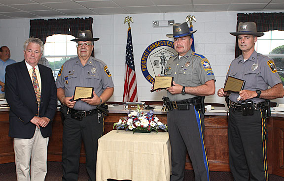 Prospect Mayor Robert Chatfield, right, honors Prospect Police officers, from left, Nelson Abarzua, Douglas Fairchild, and Andy Giordino for their role in capturing two bank robbers following a March 26 robbery of Wells Fargo Bank in Prospect.