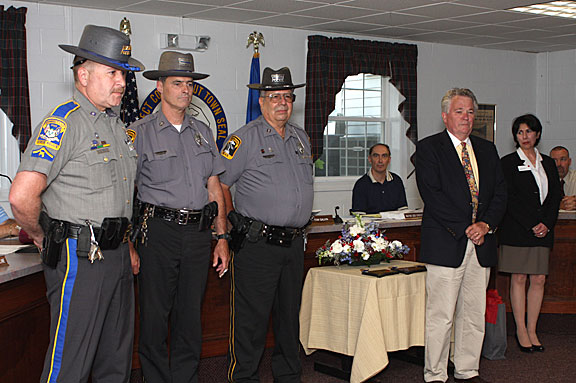 Prospect Mayor Robert Chatfield, right, honors Prospect Police officers, from left, Nelson Abarzua, Douglas Fairchild, and Andy Giordino for their role in capturing two bank robbers following a March 26 robbery of Wells Fargo Bank in Prospect.