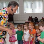 Les Julian teaches his young audiance a dragon dance during his children's concert, We All Laugh in the Same Language, July 7 at the Prospect Fire House. The concert was hosted by the Prospect Public Library.