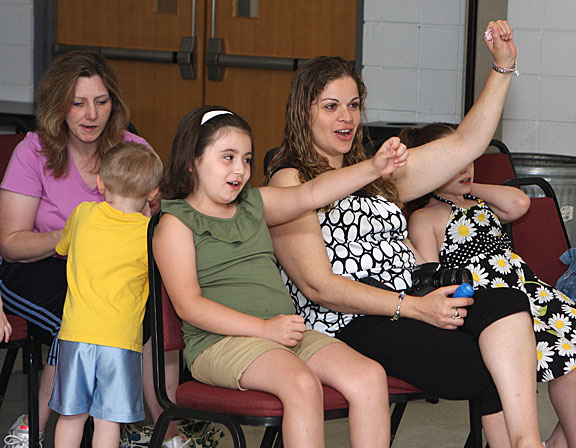 Paige Kavanaugh, 5, left, and Aryn Kavanaugh participate in Les Julian’s children's concert, We All Laugh in the Same Language, July 7 at the Prospect Fire House. The concert was hosted by the Prospect Public Library.