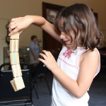 Shaylin Fisher, 7, plays with a jabob's ladder toy during a children's program at the Naugatuck Historical Society Aug. 5.